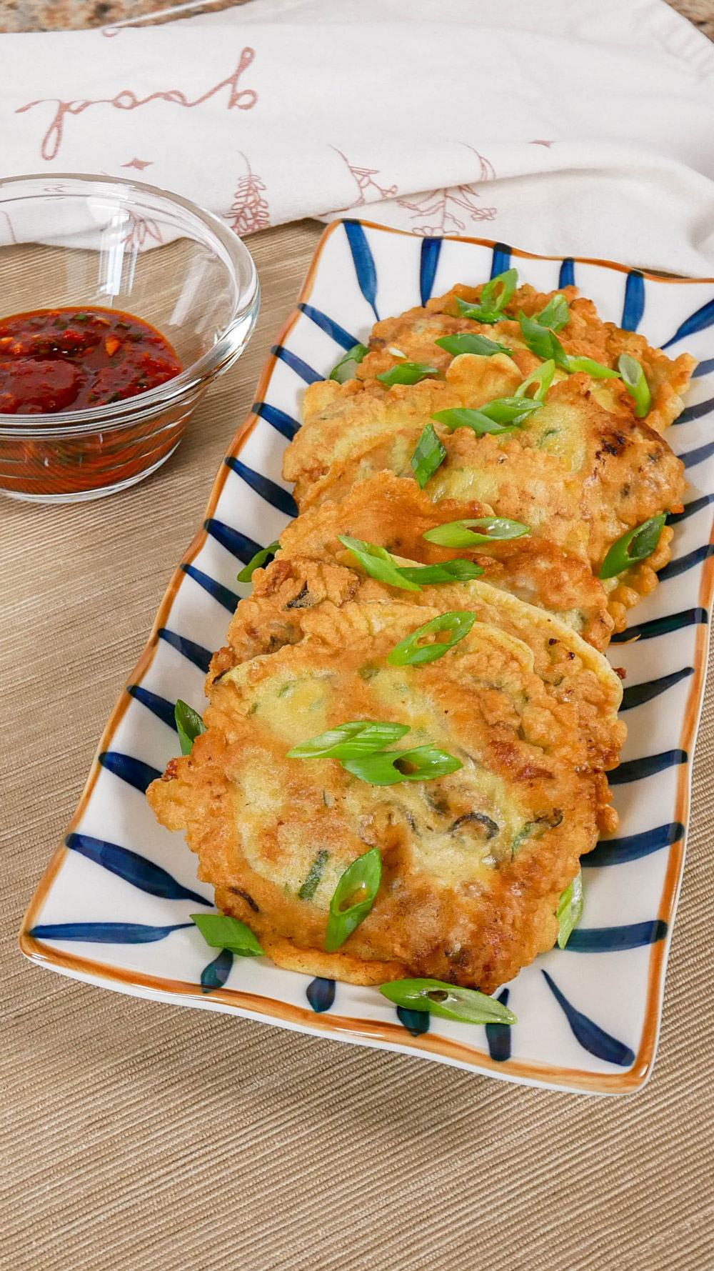 korean style oyster pancake also known as gul jeon plated on a cutting board