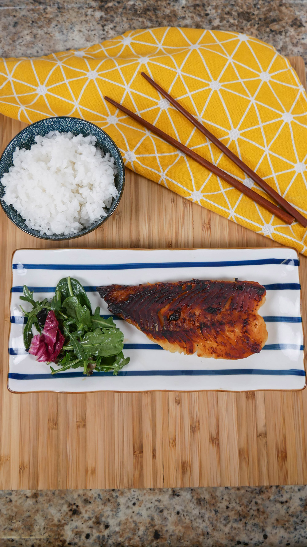 broiled miso marinated cod plated with a bowl of rice
