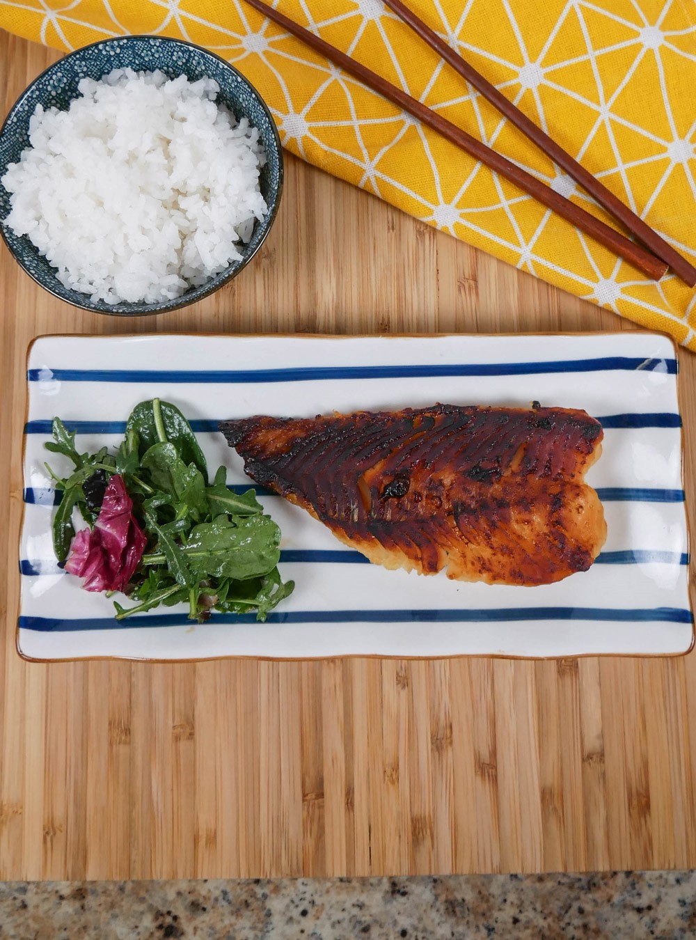 broiled miso marinated cod plated with a bowl of rice