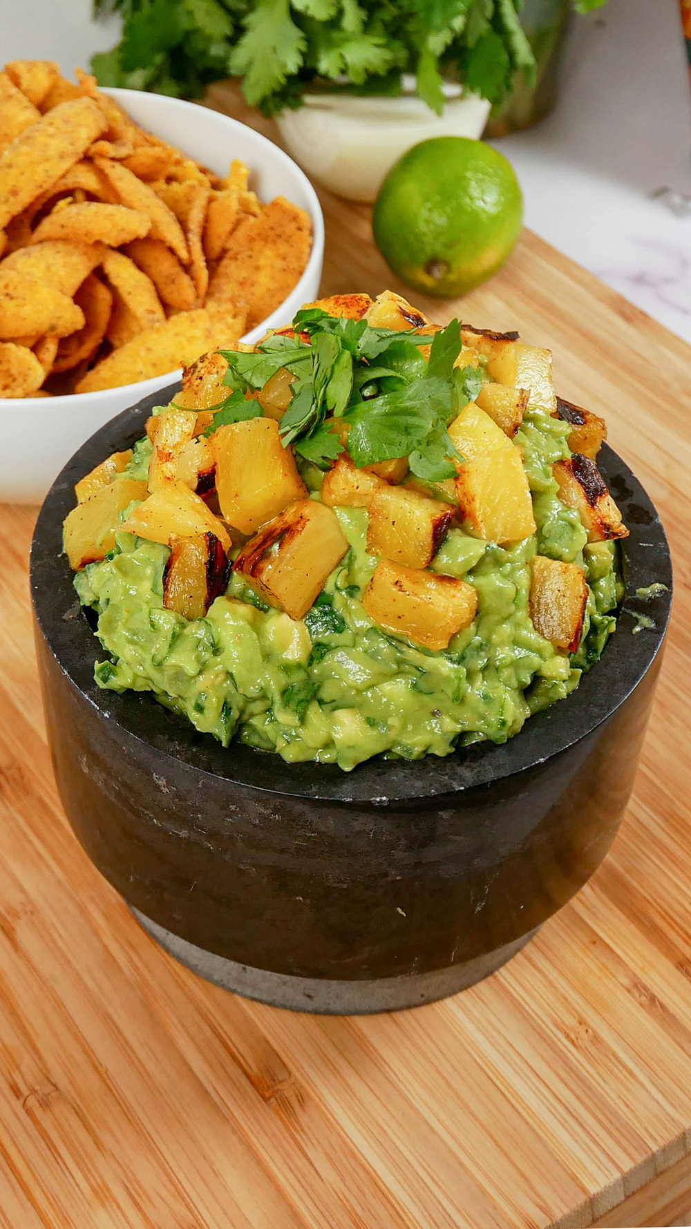 pineapple guacamole topped with grilled pineapple and cilantro