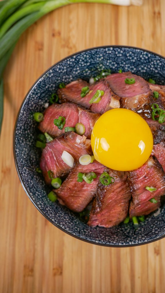 elevate your rice bowls with this ribeye steak donburi topped with